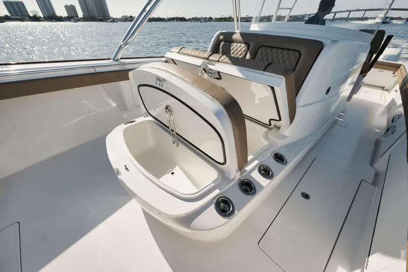 Slide: The Image of 2023 Valhalla Boatworks V-41 interior with open storage compartment, sleek design, and waterfront view. - 19