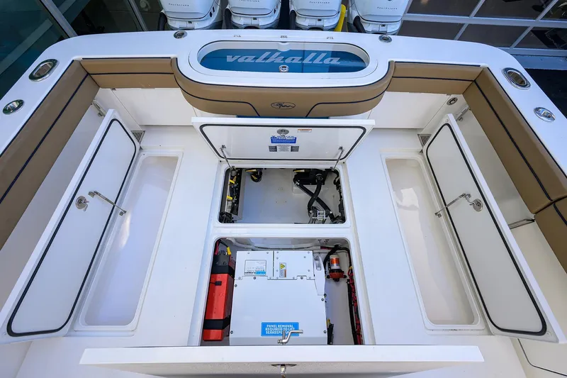 Slide: The Image of 2023 Valhalla Boatworks V-41 deck with open storage compartments and visible equipment. - 28