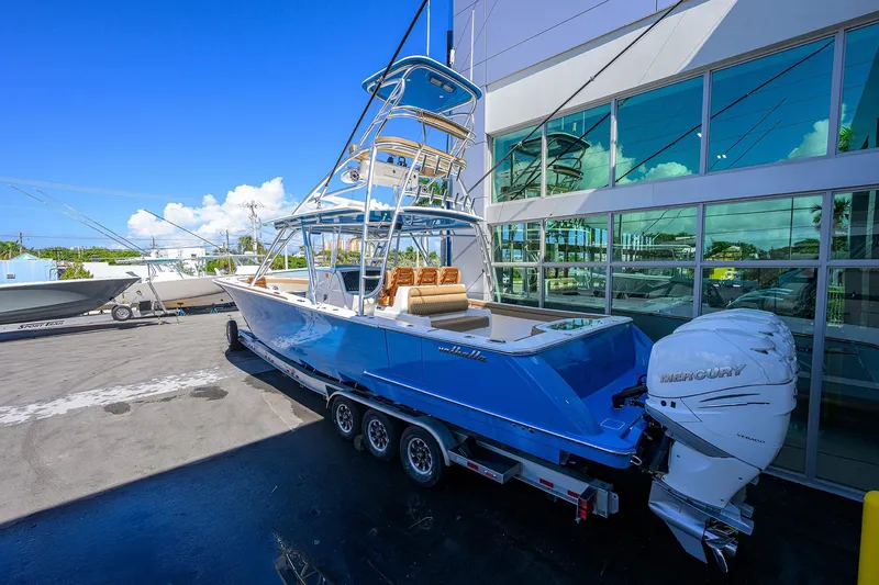 Slide: The Image of 2023 Valhalla Boatworks V-41 in blue, parked on a trailer with Mercury engines. - 29