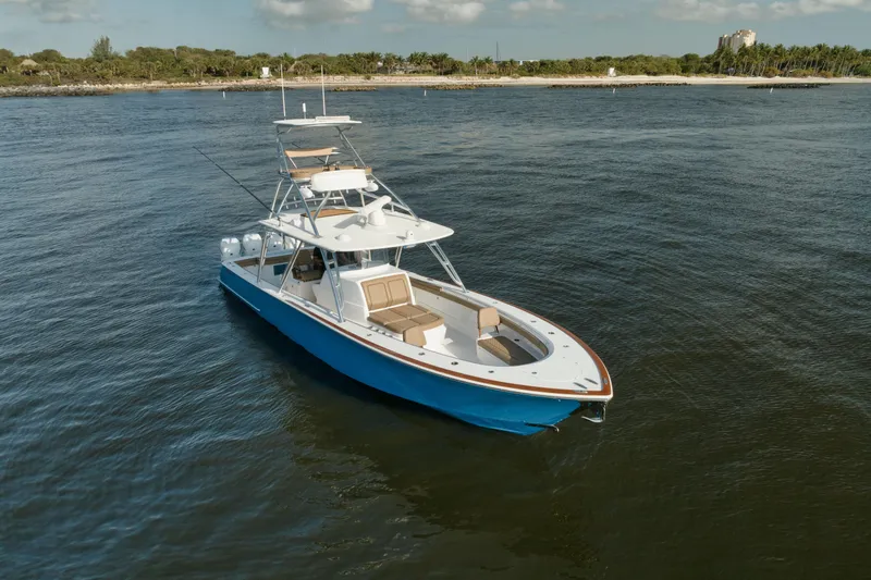 Slide: The Image of 2023 Valhalla Boatworks V-41 cruising on calm waters near a scenic shoreline. - 5