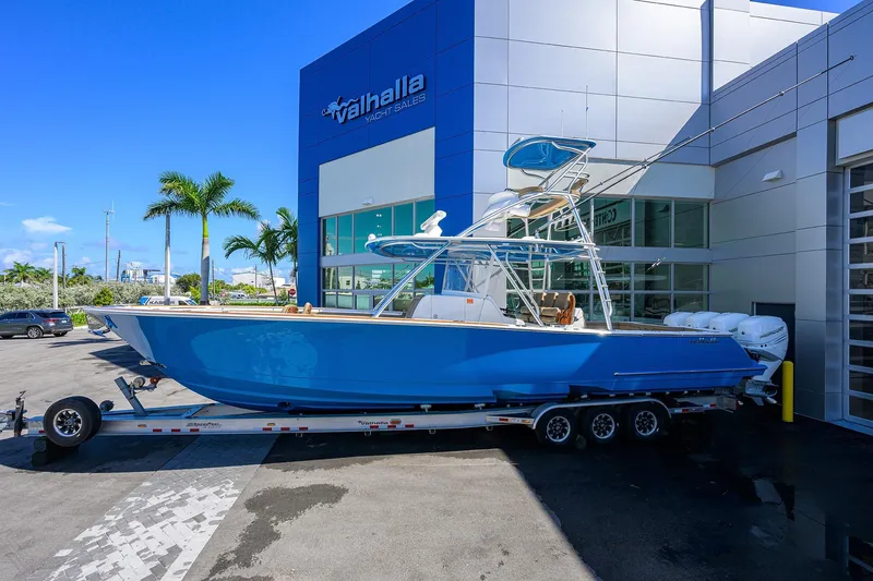 Slide: The Image of 2023 Valhalla Boatworks V-41 in blue, parked outside Valhalla Yacht Sales. - 6