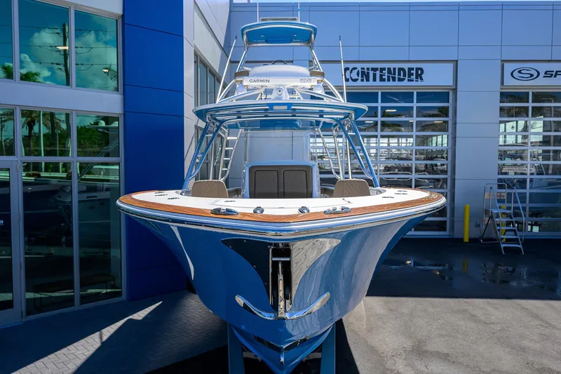 Slide: The Image of 2023 Valhalla Boatworks V-41, sleek blue design, displayed at a dealership. - 8