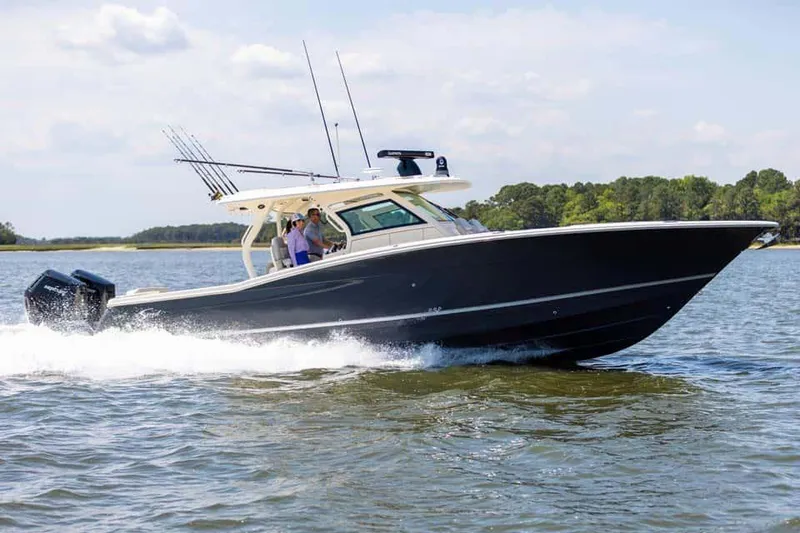 Slide: The Image of Manufacturer Provided Image: 2025 Scout 400 LXF boat cruising on a sunny day. - 2