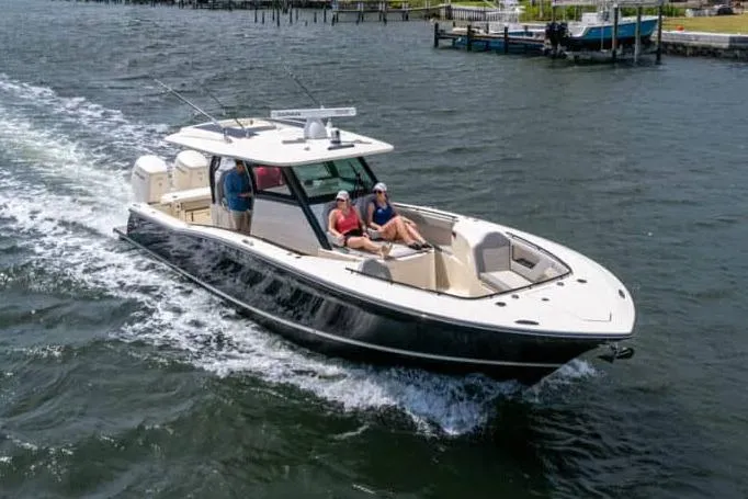 The Image of Manufacturer Provided Image: 2025 Scout 377 LXF boat cruising on water with passengers relaxing. - 0