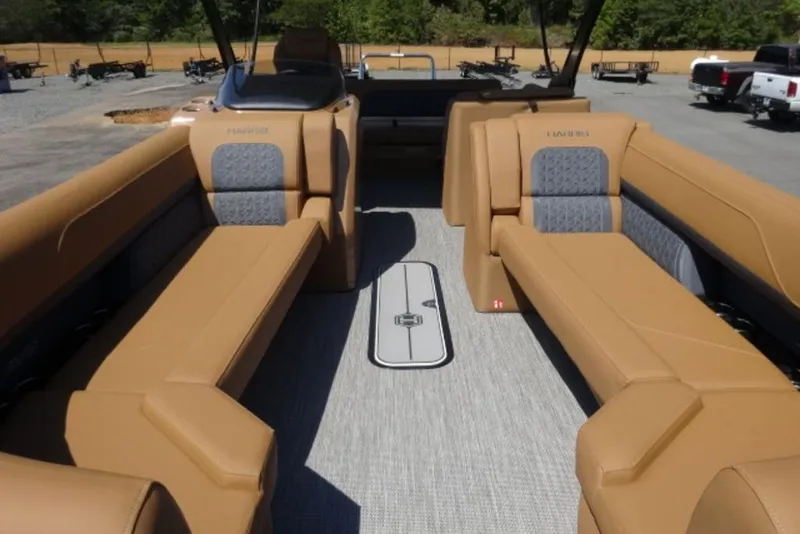 Slide: The Image of 2026 Harris Solstice 250 boat interior with tan seating and modern design. - 10