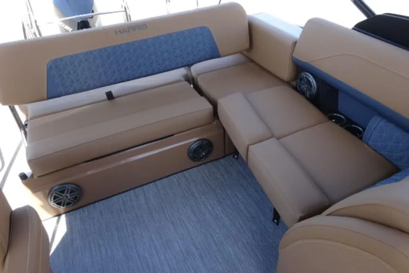 Slide: The Image of 2026 Harris Solstice 250 boat interior with tan and blue seating, featuring built-in speakers. - 3