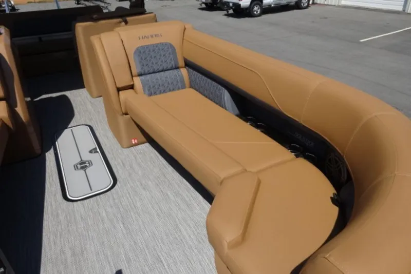 Slide: The Image of Luxurious seating on 2026 Harris Solstice 250 pontoon boat, featuring tan upholstery and modern design. - 7