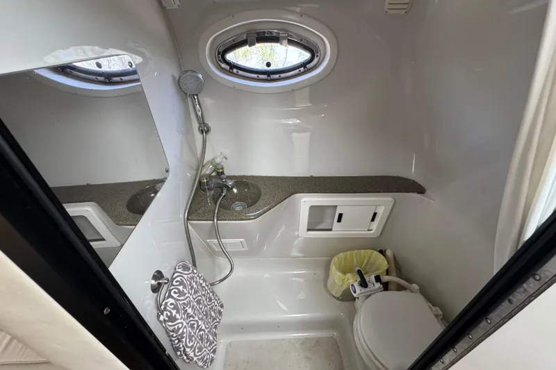 Slide: The Image of 2003 Crownline 262 CR boat bathroom with sink, shower, and toilet. - 18