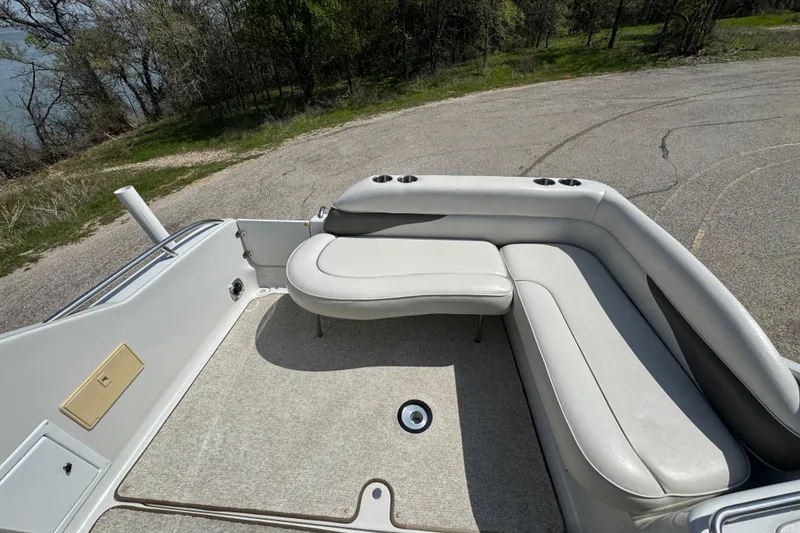 Slide: The Image of 2003 Crownline 262 CR boat interior with white seating and carpeted floor. - 19