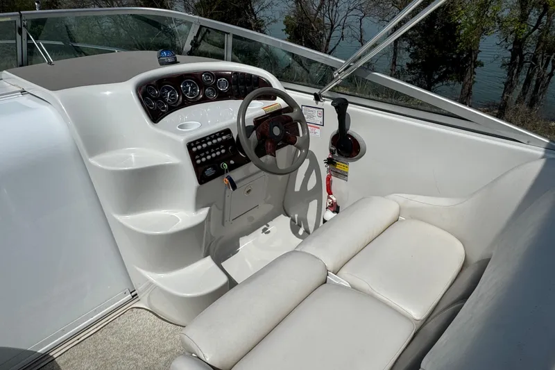 Slide: The Image of 2003 Crownline 262 CR boat cockpit with steering wheel and control panel. - 25