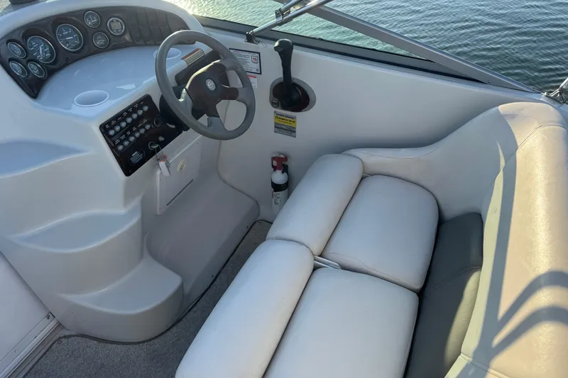 Slide: The Image of 2003 Crownline 262 CR boat cockpit with steering wheel and seating. - 30