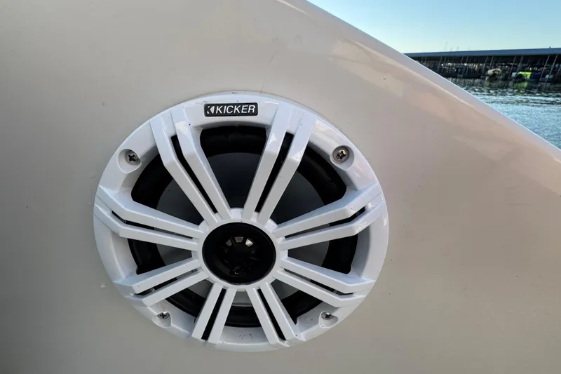 Slide: The Image of Kicker speaker on 2003 Crownline 262 CR boat, docked by the water. - 36