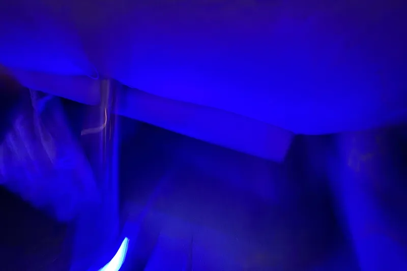 Slide: The Image of Blue-lit interior of a 2003 Crownline 262 CR boat cabin. - 43