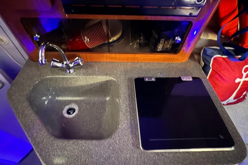 Slide: The Image of 2003 Crownline 262 CR boat interior with sink and countertop. - 45