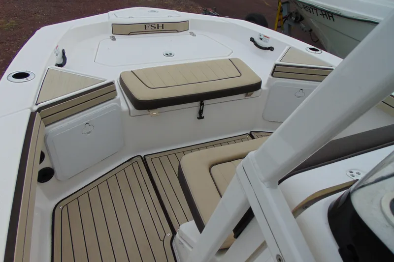Slide: The Image of 2021 Yamaha 195 FSH Sport boat interior with beige seating and storage compartments. - 10