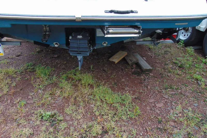 Slide: The Image of Rear view of a 2021 Yamaha 195 FSH Sport boat on a gravel surface. - 6