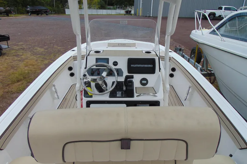 Slide: The Image of 2021 Yamaha 195 FSH Sport boat cockpit with steering wheel and Humminbird display. - 8