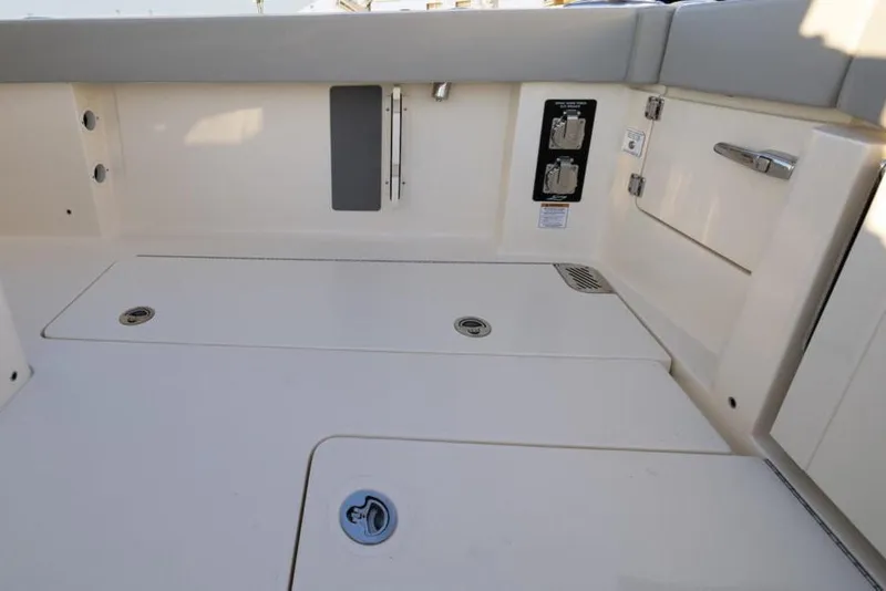 Slide: The Image of Manufacturer Provided Image: 2025 Scout 357 LXF boat interior with storage compartments and control panel. - 6