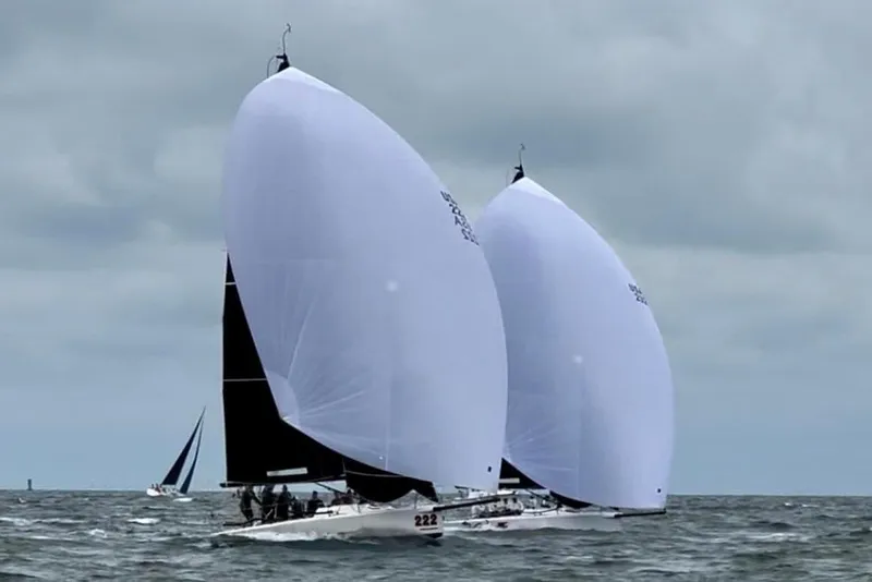 Slide: The Image of Sailboats racing on the ocean, featuring 2010 Melges 32 models with large white sails. - 1