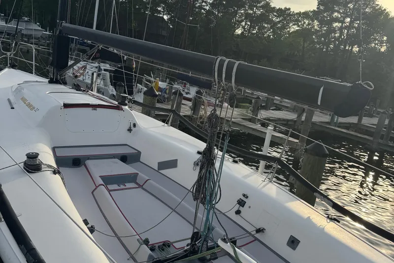 Slide: The Image of 2010 Melges 32 sailboat docked at marina, featuring sleek design and rigging. - 10