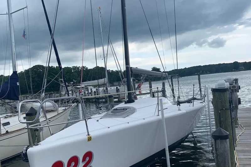 Slide: The Image of 2010 Melges 32 sailboat docked at a marina under cloudy skies. - 5