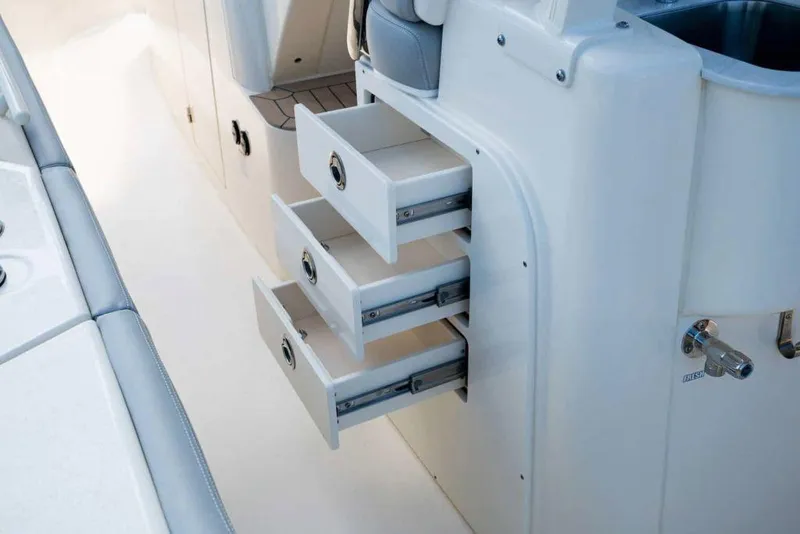 Slide: The Image of Manufacturer Provided Image: 2025 Scout 330 LXF boat interior with open storage drawers. - 10
