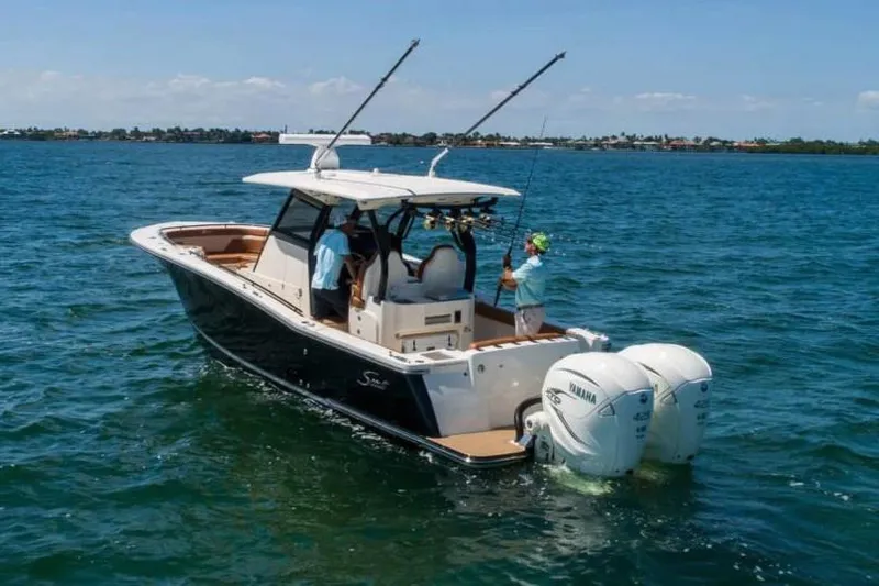 Slide: The Image of Manufacturer Provided Image: 2025 Scout 330 LXF boat on open water, featuring dual Yamaha engines. - 2