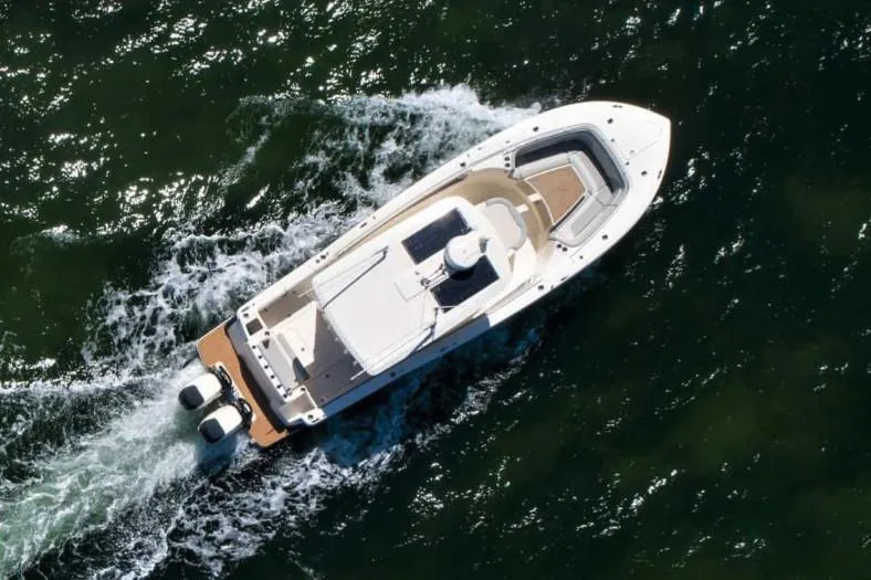 Slide: The Image of Manufacturer Provided Image: Aerial view of 2025 Scout 330 LXF boat cruising on water. - 4