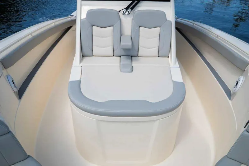 Slide: The Image of Manufacturer Provided Image: 2025 Scout 330 LXF boat interior with cushioned seating and sleek design. - 7
