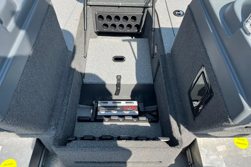 Slide: The Image of Interior view of a 2013 Lund 1875 Pro-V IFS boat, showcasing storage compartments. - 10