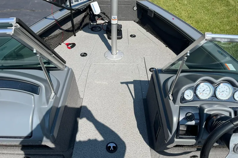 Slide: The Image of 2013 Lund 1875 Pro-V IFS boat interior with dashboard and open windshield. - 11