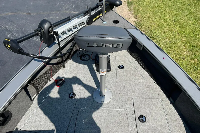 Slide: The Image of 2013 Lund 1875 Pro-V IFS boat interior with Minn Kota trolling motor and seating. - 12