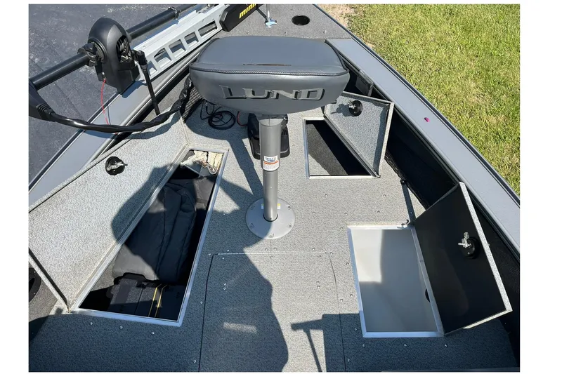 Slide: The Image of 2013 Lund 1875 Pro-V IFS boat interior with storage compartments and seating. - 13