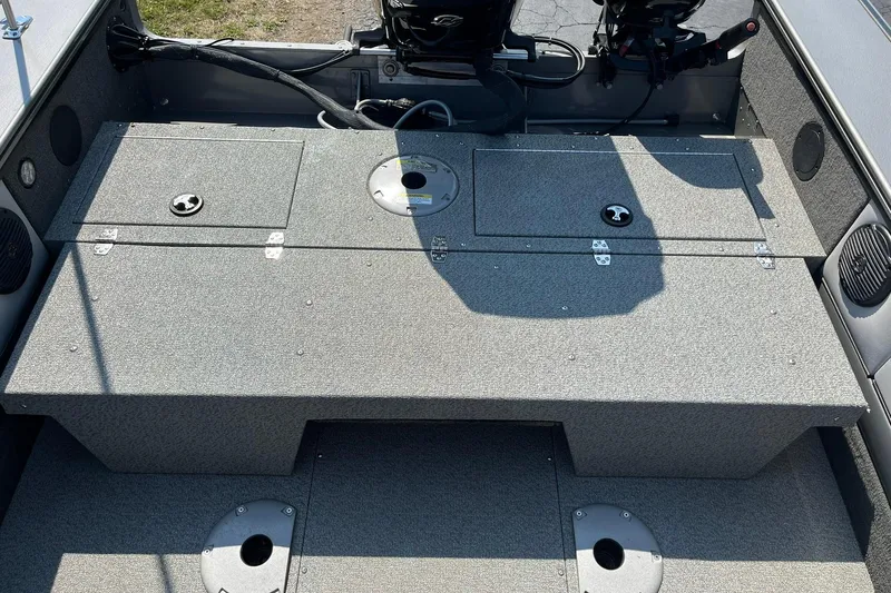 Slide: The Image of 2013 Lund 1875 Pro-V IFS boat interior with storage compartments and motor. - 16