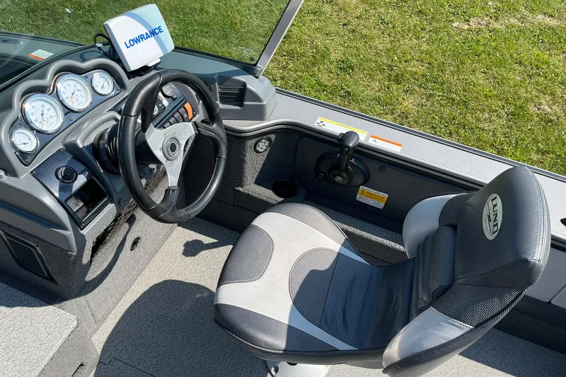 Slide: The Image of 2013 Lund 1875 Pro-V IFS boat interior with steering wheel and Lowrance display. - 19