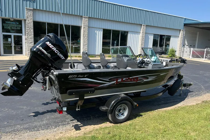 Slide: The Image of 2013 Lund 1875 Pro-V IFS boat with Mercury engine outside dealership. - 2