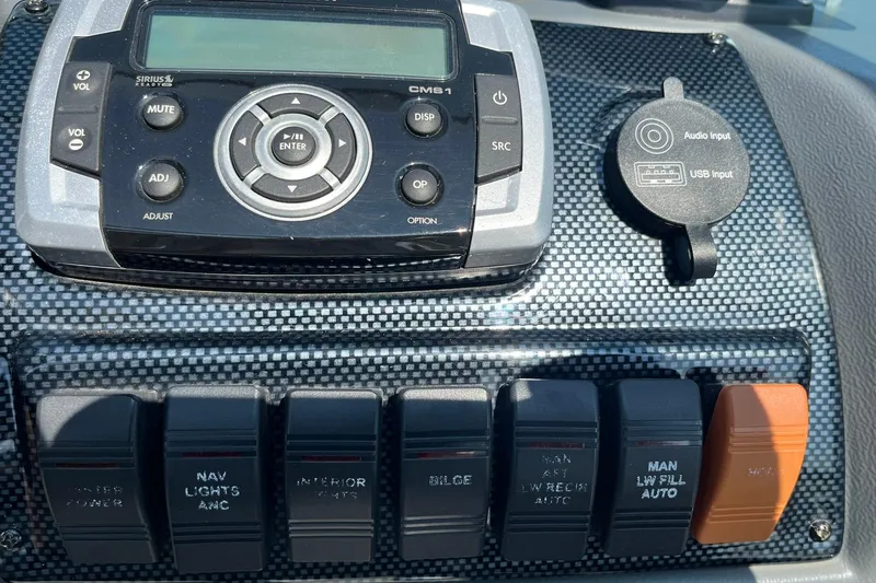 Slide: The Image of Control panel of a 2013 Lund 1875 Pro-V IFS boat with audio system and switches. - 21