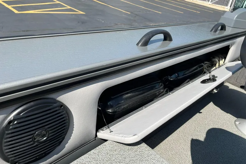 Slide: The Image of 2013 Lund 1875 Pro-V IFS boat interior storage compartment with speaker and handle. - 24