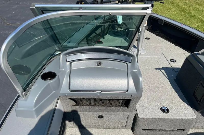Slide: The Image of 2013 Lund 1875 Pro-V IFS boat interior with windshield and storage compartments. - 25