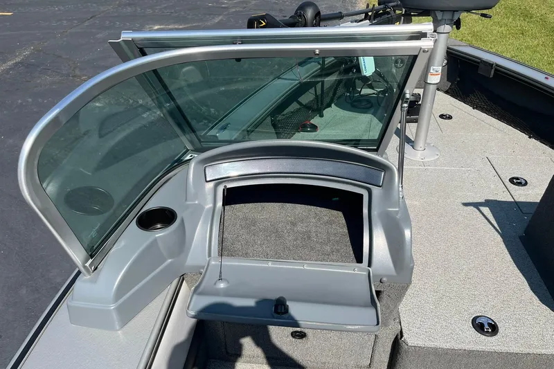 Slide: The Image of 2013 Lund 1875 Pro-V IFS boat interior with open windshield and storage compartment. - 26