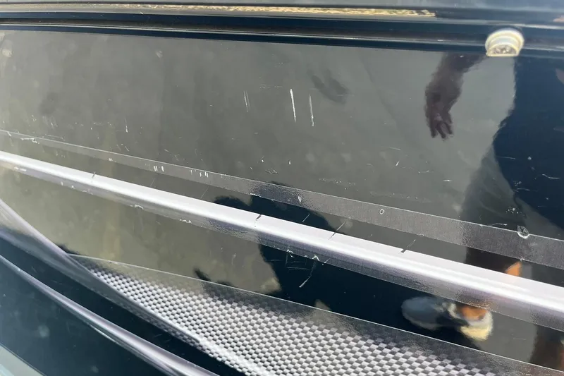 Slide: The Image of Close-up of 2013 Lund 1875 Pro-V IFS boat hull with visible scratches. - 33