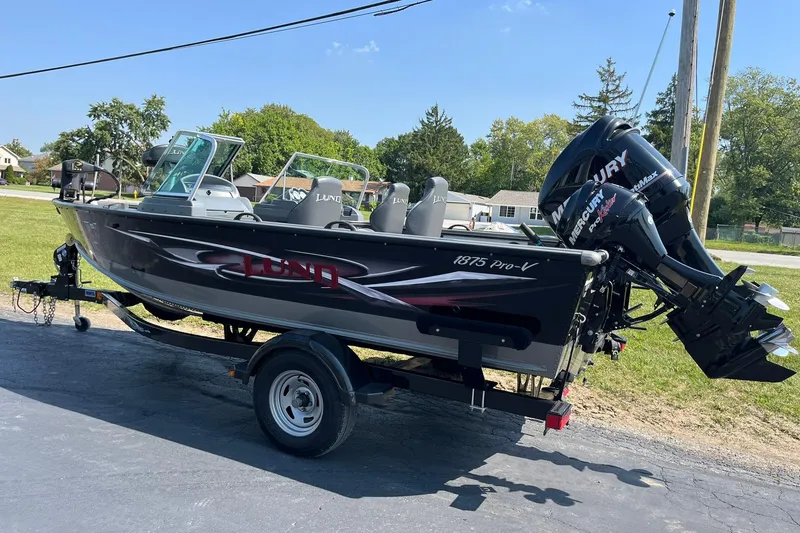 Slide: The Image of 2013 Lund 1875 Pro-V IFS fishing boat on trailer with Mercury outboard motor. - 4