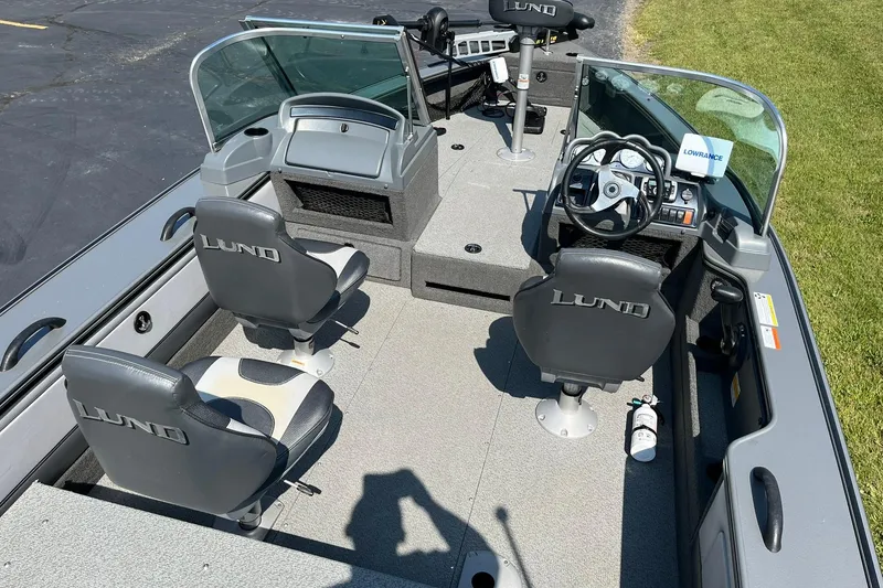 Slide: The Image of 2013 Lund 1875 Pro-V IFS boat interior with steering wheel, seats, and control panel. - 6