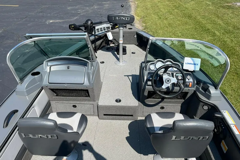 Slide: The Image of 2013 Lund 1875 Pro-V IFS boat interior with steering wheel and seating. - 7