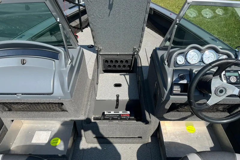 Slide: The Image of 2013 Lund 1875 Pro-V IFS boat interior with steering wheel and dashboard gauges. - 9