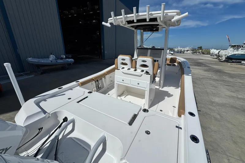 Slide: The Image of 2026 Caymas 291 boat docked, featuring spacious deck and modern seating. - 10