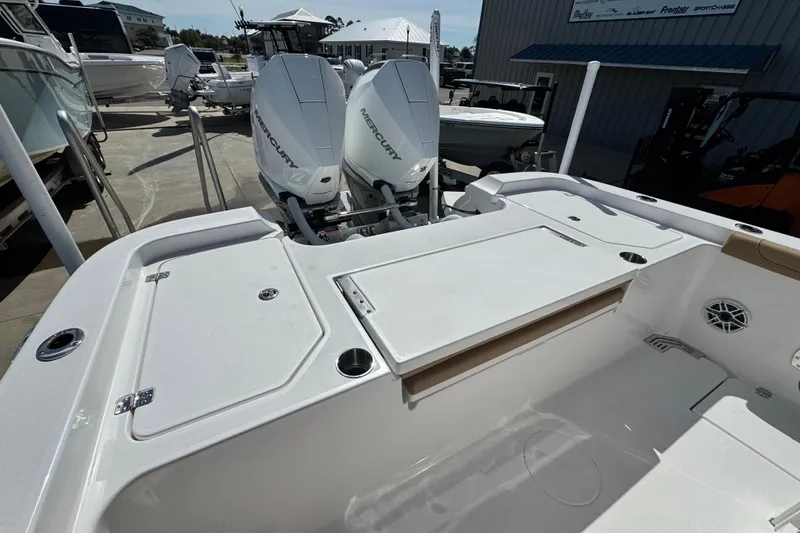 Slide: The Image of 2026 Caymas 291 boat with dual Mercury engines, docked at a marina. - 12