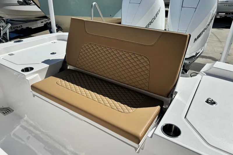 Slide: The Image of 2026 Caymas 291 boat with tan quilted seating and dual Mercury engines. - 15