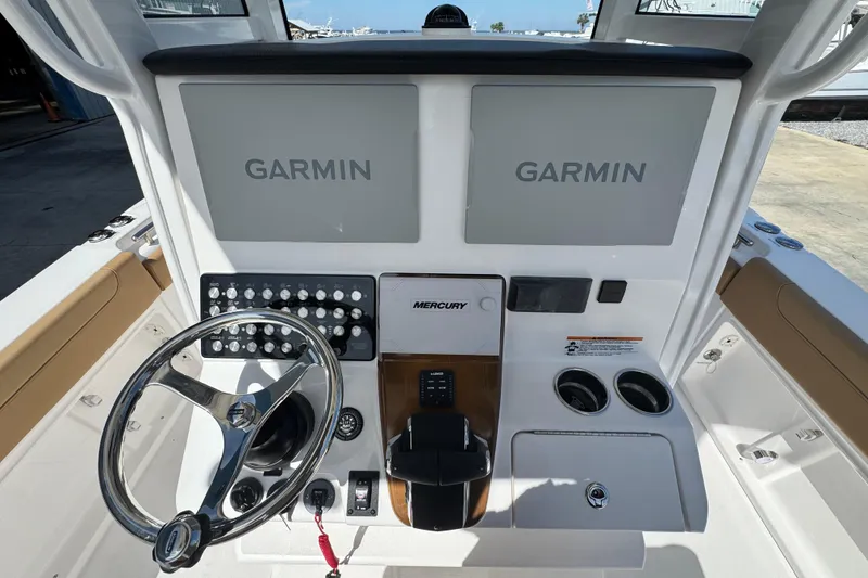 Slide: The Image of Helm of 2026 Caymas 291 boat featuring dual Garmin displays and Mercury controls. - 18