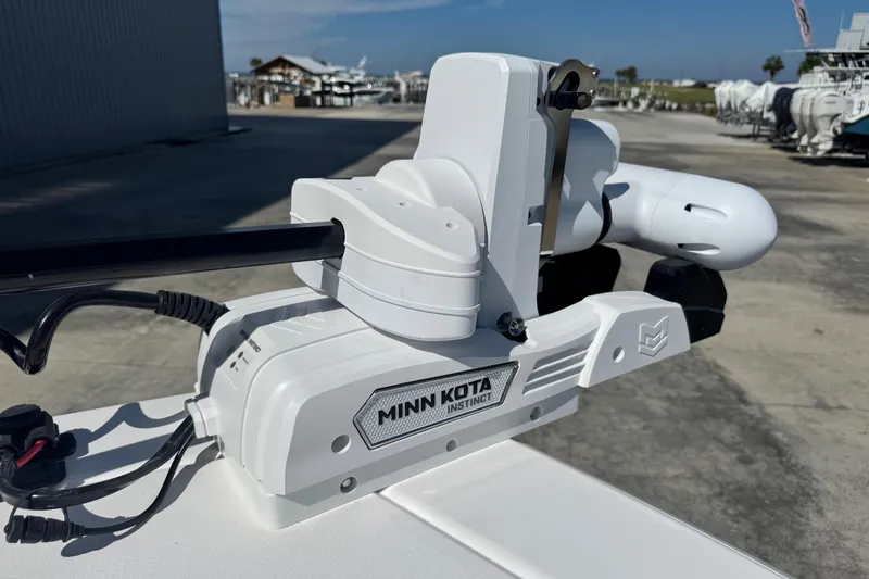 Slide: The Image of Minn Kota Instinct motor on 2026 Caymas 291 boat, dockside view. - 28